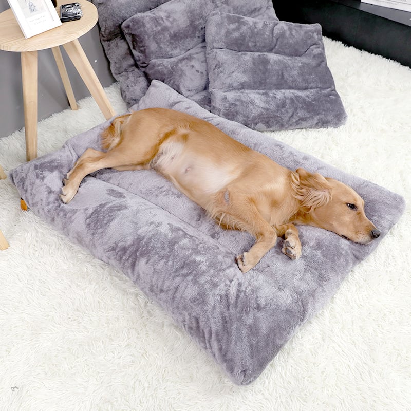 Dog lying on the gray Plush Dog Sleeping Mat, a fluffy cozy pet bed