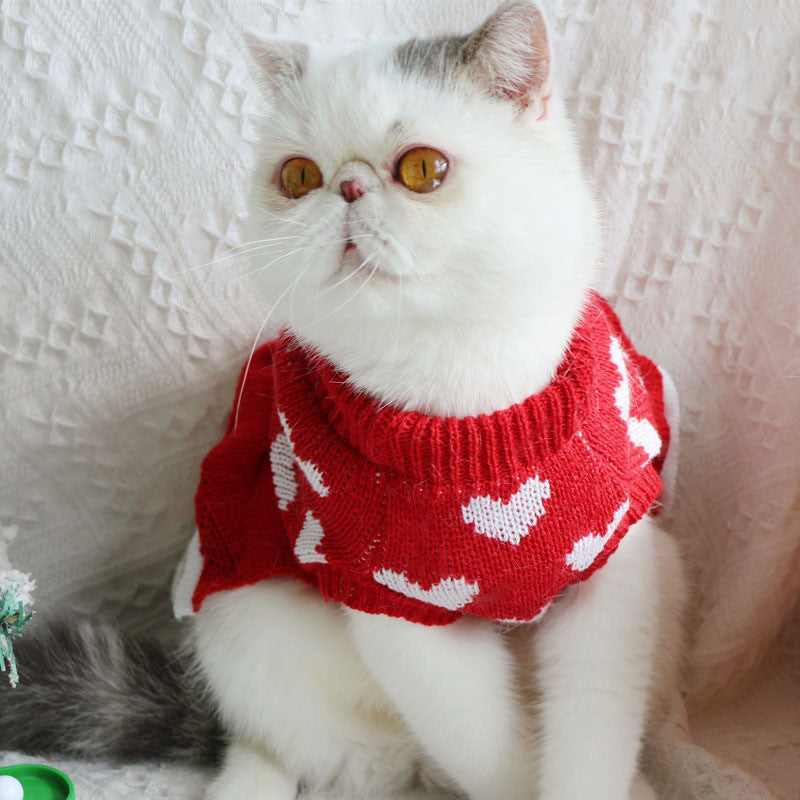 Festive Red Dog Sweater Dress – red sweater with white hearts on a textured white background