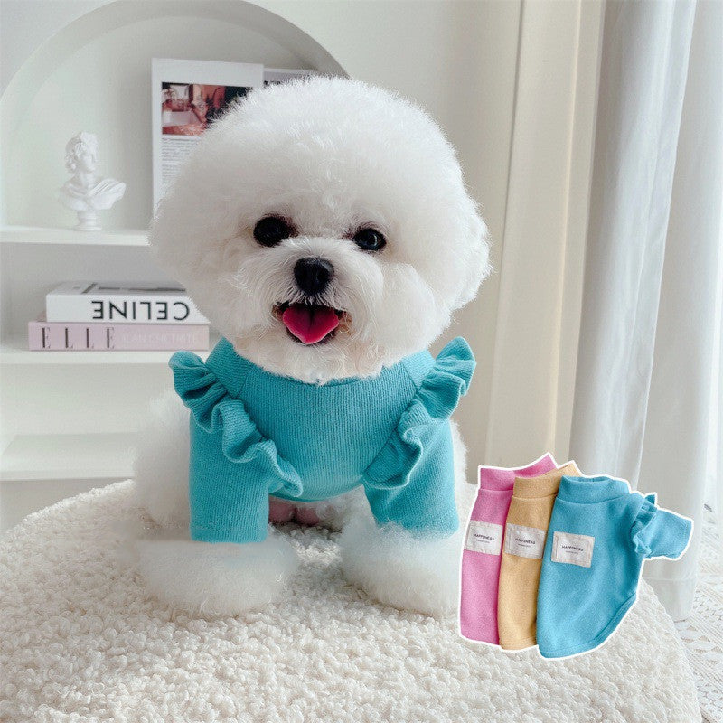 Ruffle-Sleeve Dog Sweater – white dog wearing a blue sweater with ruffles, sitting on a white surface