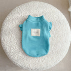 Ruffle-Sleeve Dog Sweater – blue pet sweater with a 'Happiness' label on a textured white surface