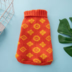 High-Neck Knit Dog Sweater – coral knitted dog sweater with yellow patterns on a blue background